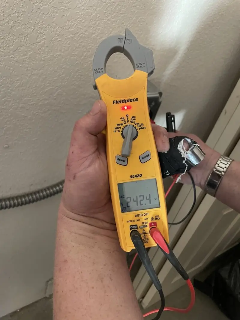 Voltage testing with clamp meter during Recessed Lighting Installation in Cameron